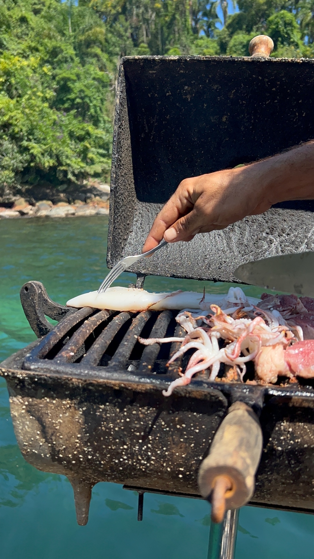 Lula e frutos do mar grelhados na churrasqueira do barco